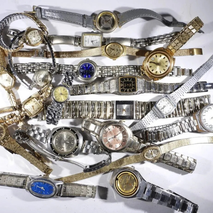 Assorted women’s wristwatches with silver and gold bands displayed together.