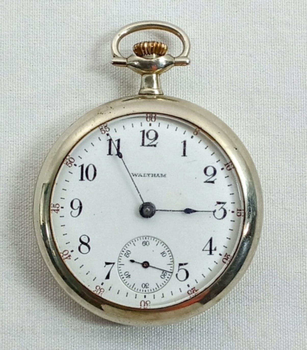 Vintage Waltham pocket watch featured in our vintage watch auction – classic white dial with black numerals and subdial.