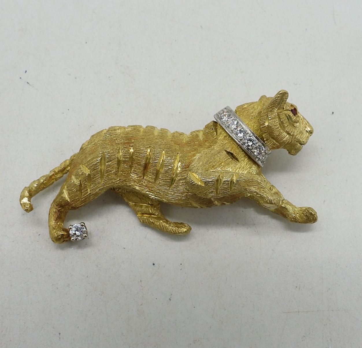 Gold tiger brooch with diamond accents – featured in Sterling Jewelry Auction