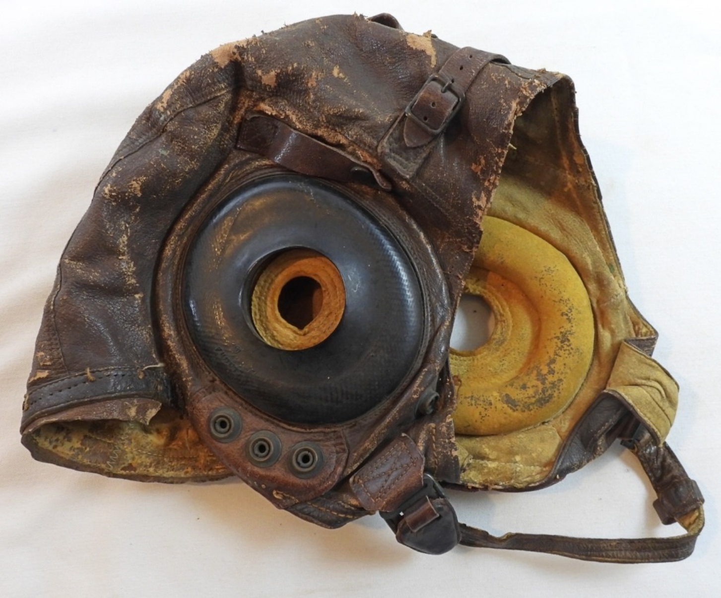 Vintage World War II leather pilot oxygen mask from a military collectibles auction, featuring authentic aviation gear and wartime memorabilia.
